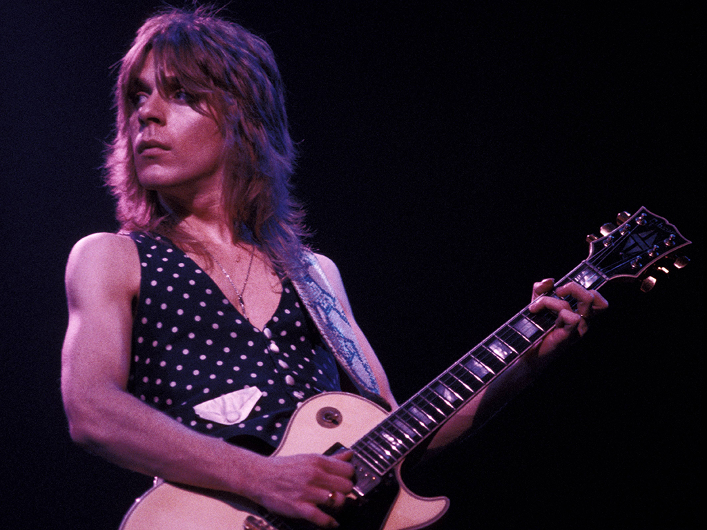 Randy Rhoads playing a Gibson Les Paul guitar, performing live onstage with Ozzy Osbourne in the early 1980s.