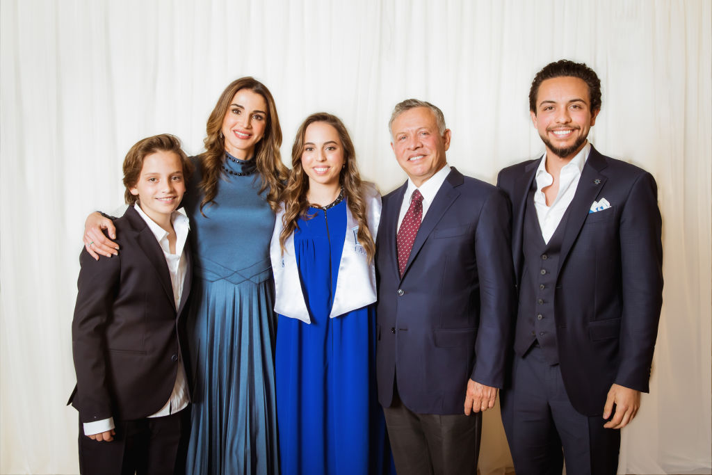 In this handout image provided by the Royal Hashemite Court, Jordan’s King Abdullah II, his wife Queen Rania, Crown Prince Al Hussein and Prince Hashem attend the graduation ceremony of Princess Salma from the International Academy on May 22, 2018 at Amman, Jordan.