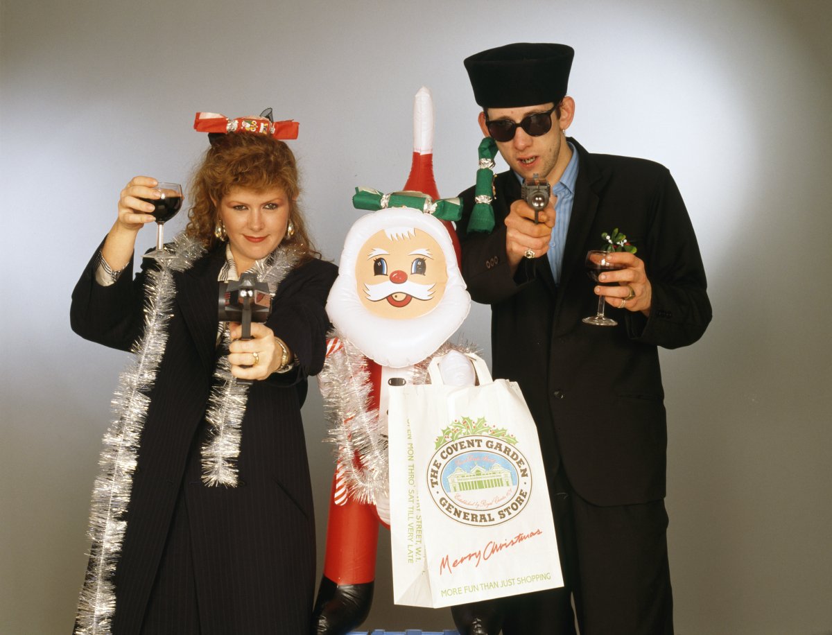 Kirsty MacColl and Shane MacGowan (The Pogues frontman) with with toy guns and an inflatable Santa in a festive scenario, circa 1987.