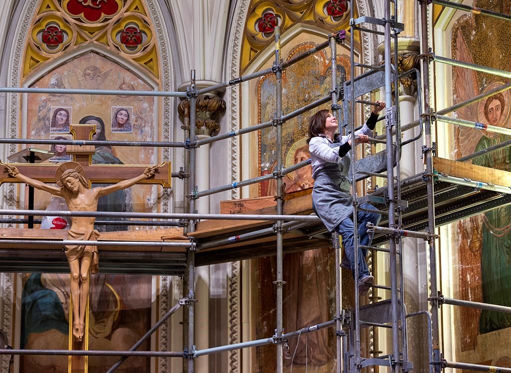 Jennifer Fotheringham, an art conservator, works on the restoration of the murals over the altar at Saint Mary's Cathedral Basilica in Halifax on Monday, Dec. 2, 2019.
