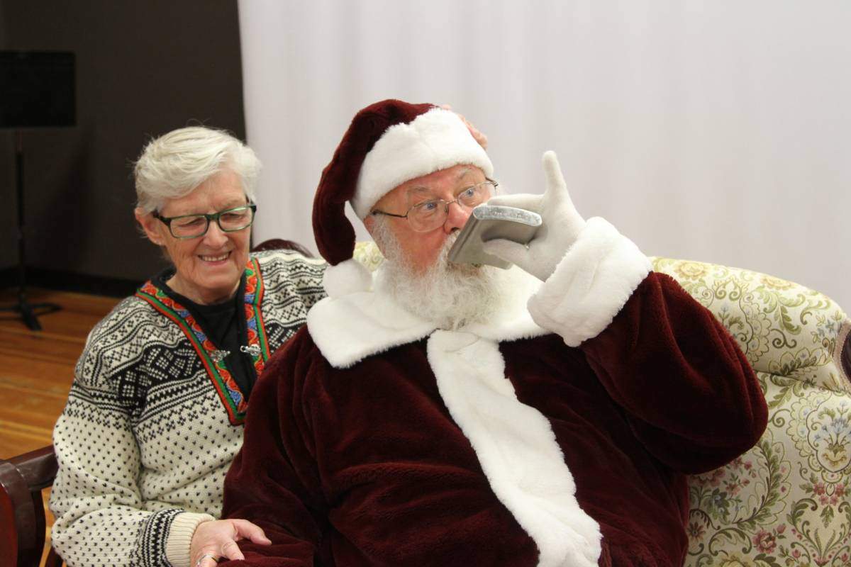 Gary Haupt pretends to drink from a flask at the Shatford Centre Christmas market.