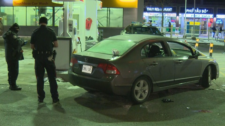 Police investigating the scene of where the car made its way to after a shooting along Highway 400 in Toronto.
