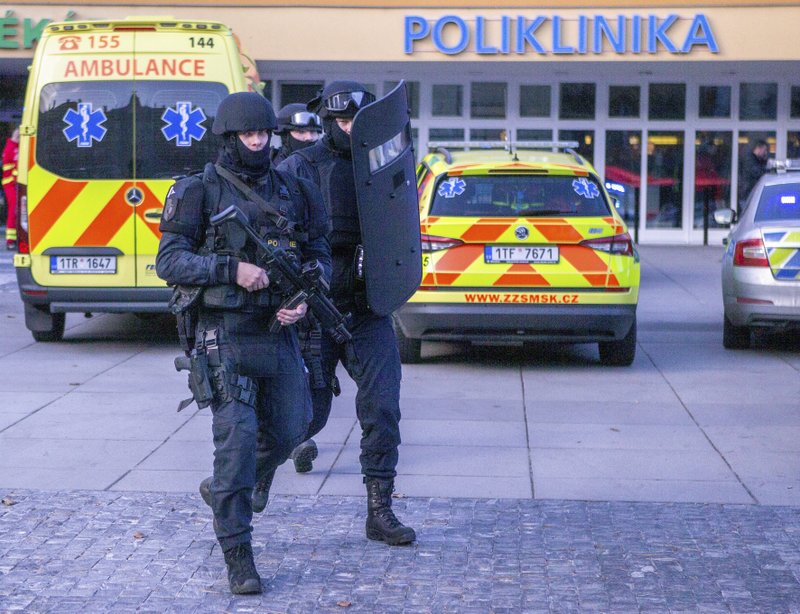Police personnel outside the Ostrava Teaching Hospital after a shooting incident in Ostrava, Czech Republic, Tuesday, Dec. 10, 2019. Police and officials say six people have been killed and two people injured in a shooting in a hospital in the eastern Czech Republic.