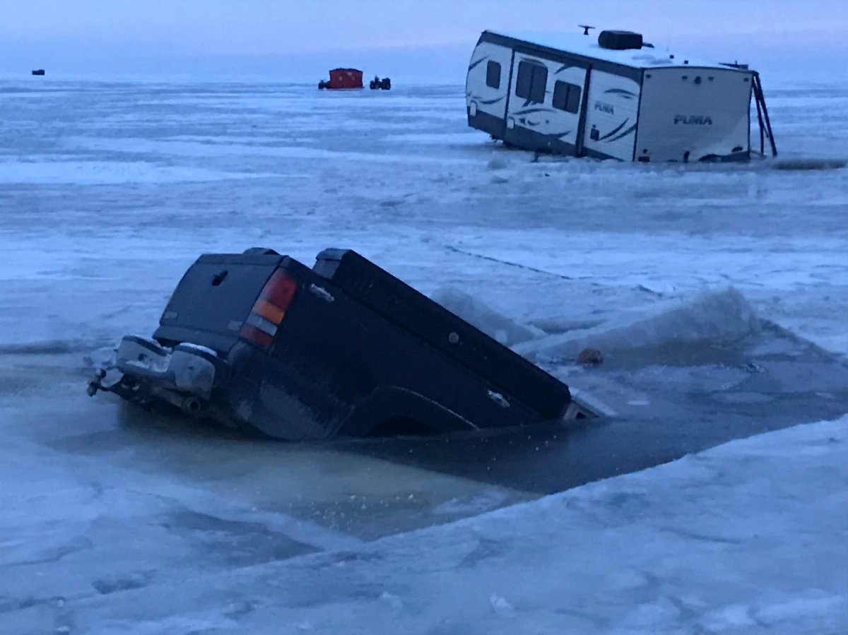 A truck and trailer partially submerged in Lake Winnipeg.