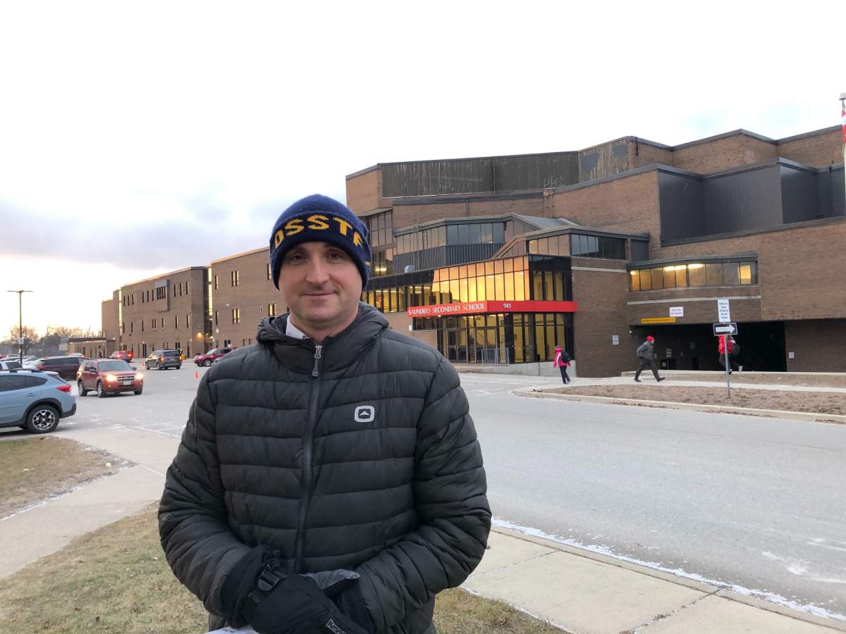 OSSTF Thames Valley District president John Bernans joins an information picket outside Saunders Secondary School on Wednesday.