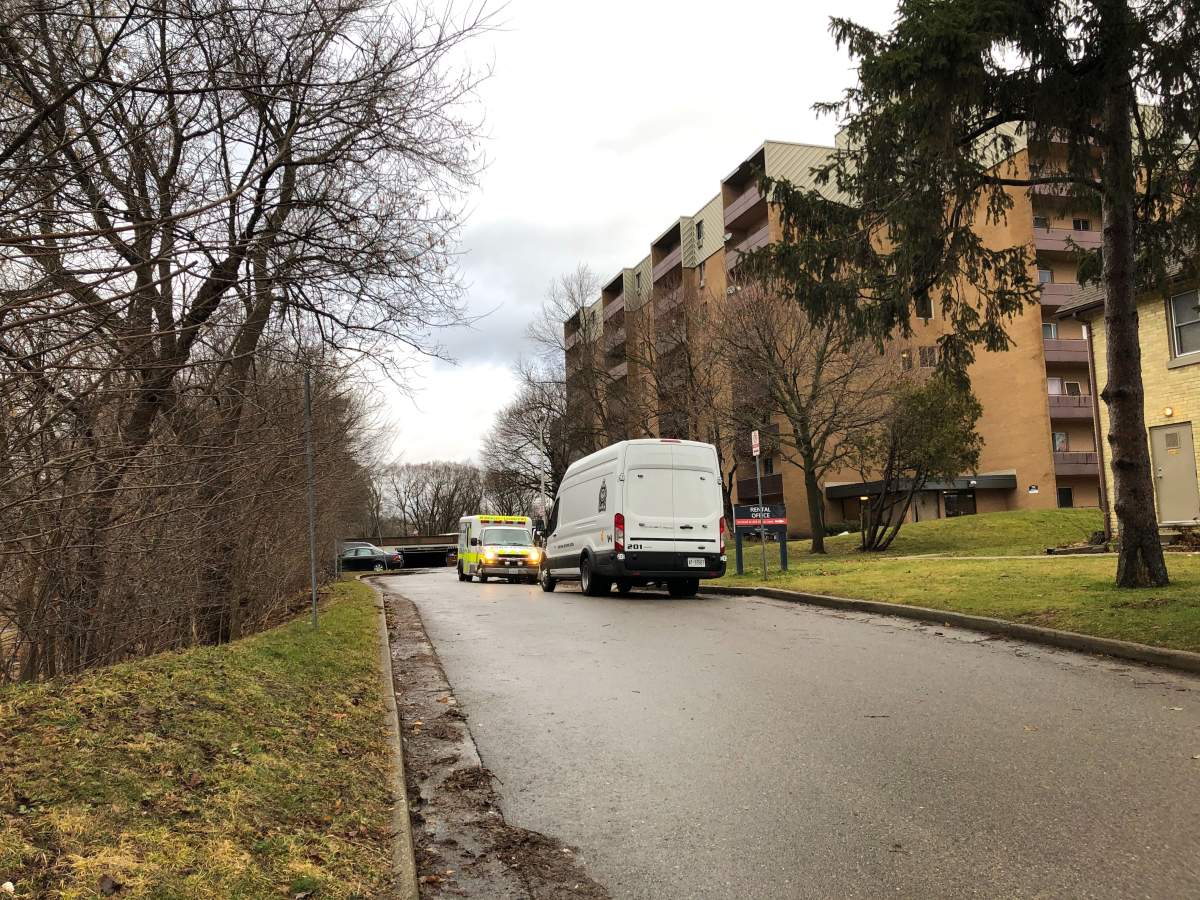 A London police forensics van is joined by an ambulance outside the underground parking garage at 750 Kipps Lane.