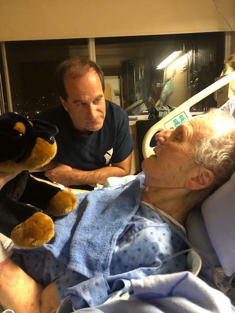 Al Anderson comforts his mother in hospital, after she was the victim of a violent care home attack.