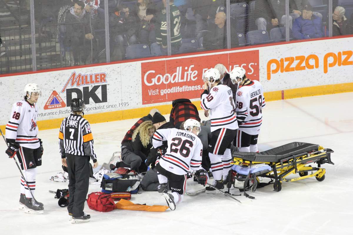 Medical personnel attend to injured Niagara IceDogs goaltender Tucker Tynan during a game against the London Knights on Dec. 12, 2019.