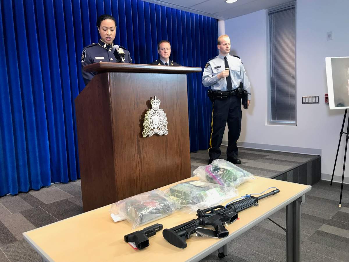 RCMP and CBSA officials show off drugs, guns and cash seized as a part of a major fentanyl import bust from 2017. 