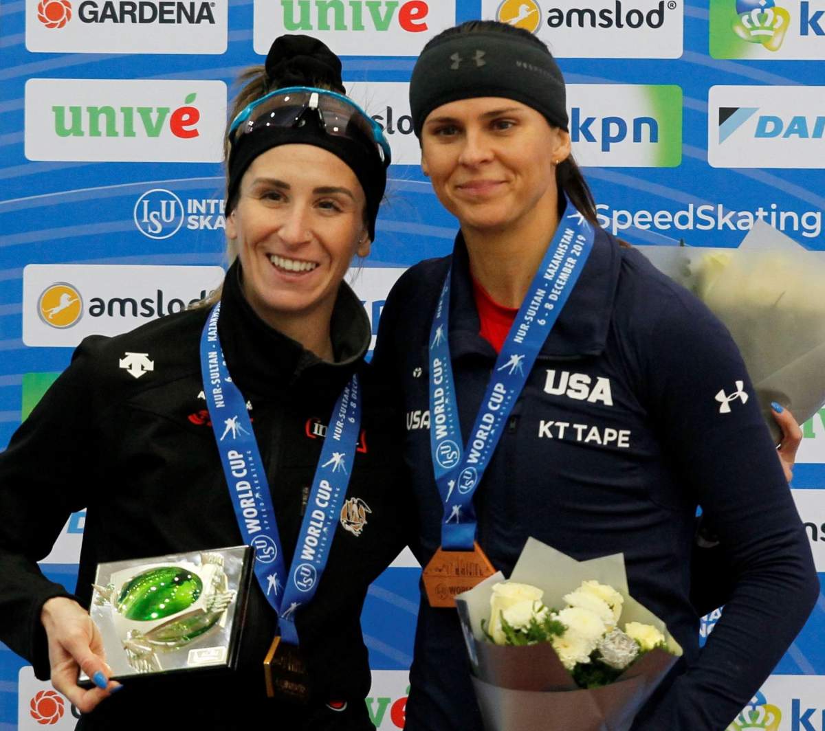 Gold medalist Ivanie Blondin of Canada (left) and Silver medalist Brittany Bowe of the USA (right) pose on the podium after the Women's 1500m race at the ISU Speed Skating World Cup in Nur-Sultan, Kazakhstan, Dec. 8, 2019.