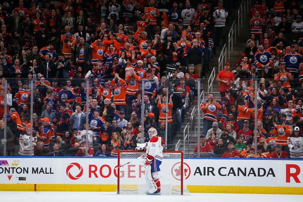 Montreal Canadiens goalie Carey Price, centre, looks away as Edmonton Oilers' fans cheer the game-winning goal during third period NHL hockey action in Edmonton, Saturday, Dec. 21, 2019.