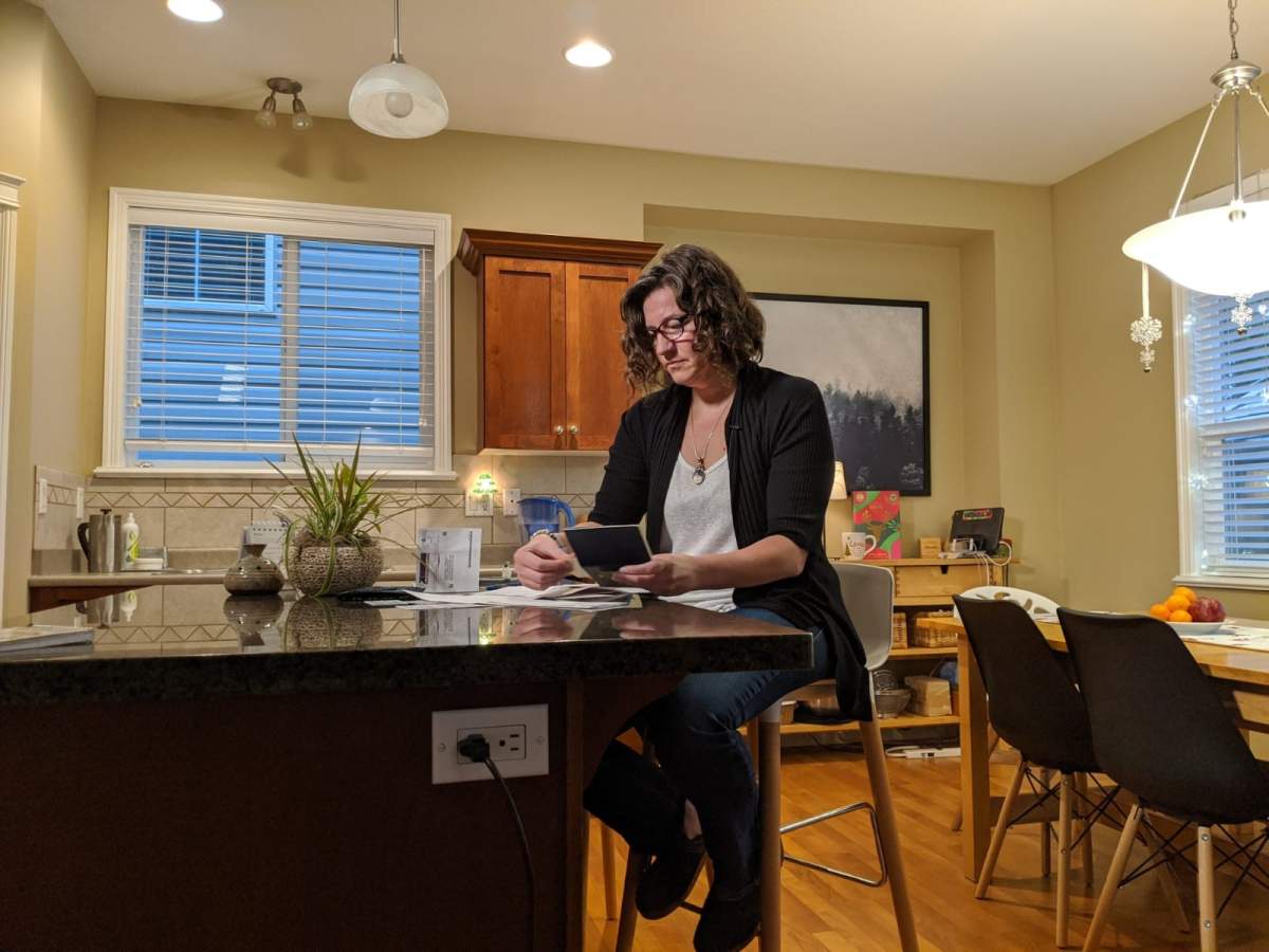 Mandy Kuelz looks over the ICBC documents she's collected during her months-long battle to get her name spelled correctly on her driver's licence in her Maple Ridge home on Dec. 12, 2019.