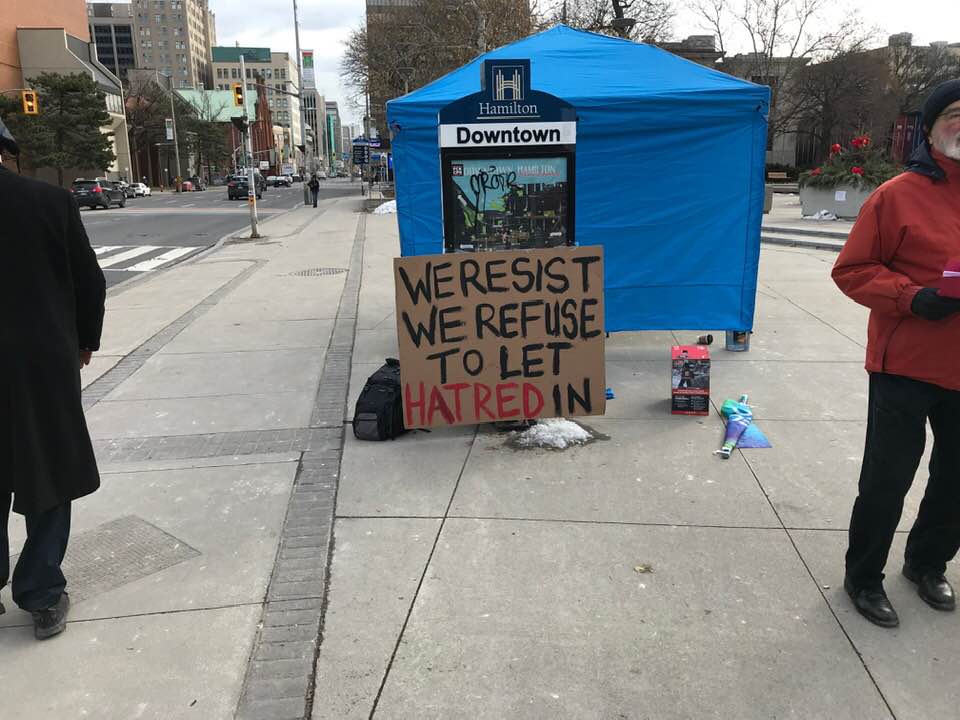 A sign out front of Hamilton city hall during a Saturday protest.