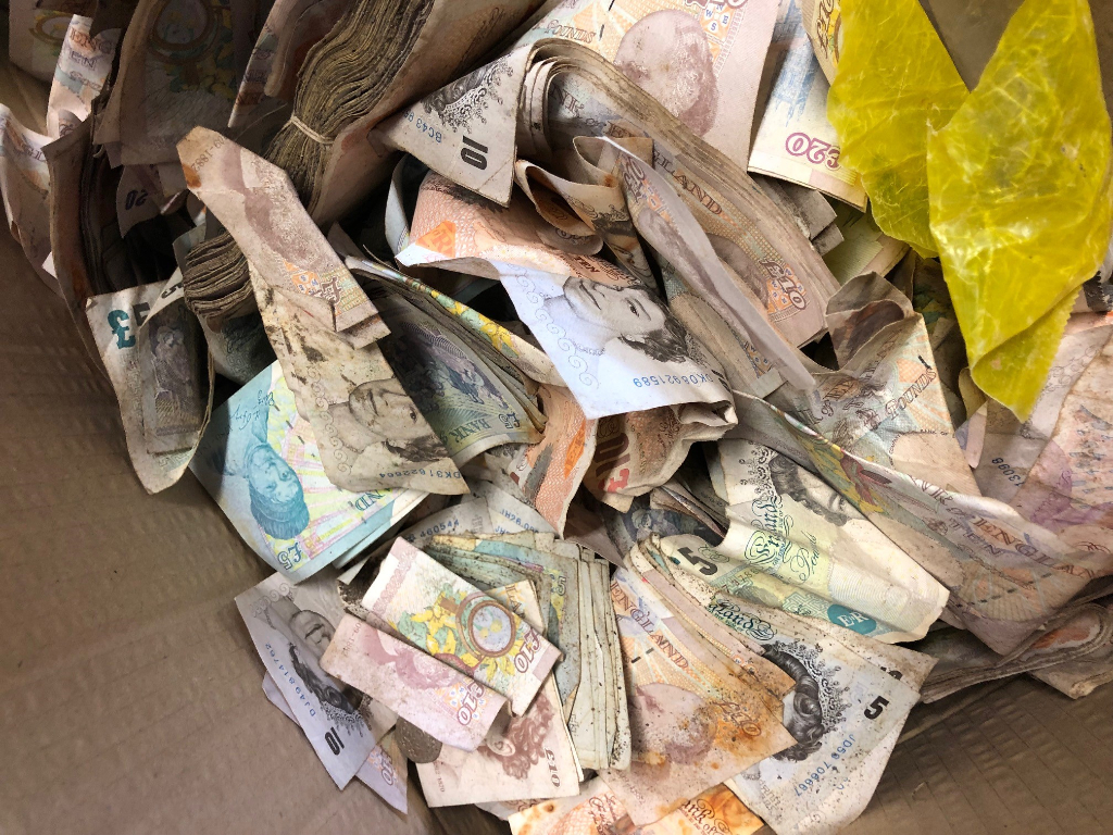 Scrap metal workers cut open an old safe and found thousands of dollars in cash inside.