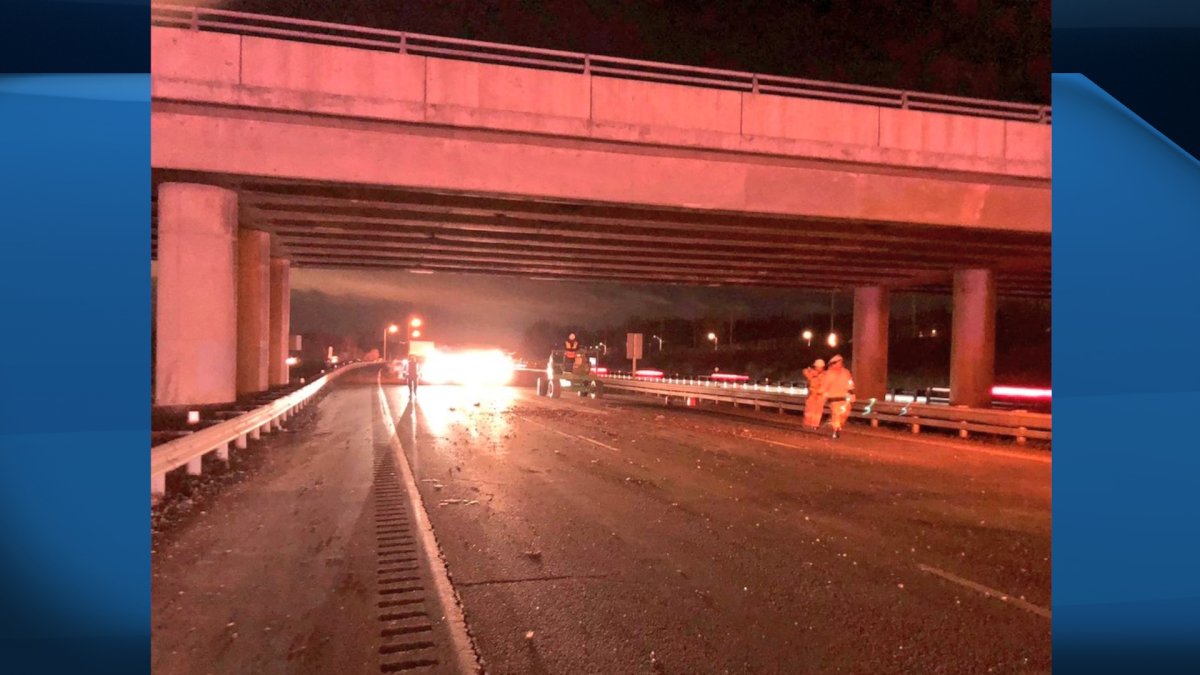 Crews from the Ministry of Transportation inspect damage to an overpass on Highway 403 near Burlington after a dump truck crashed into it on Wednesday night.