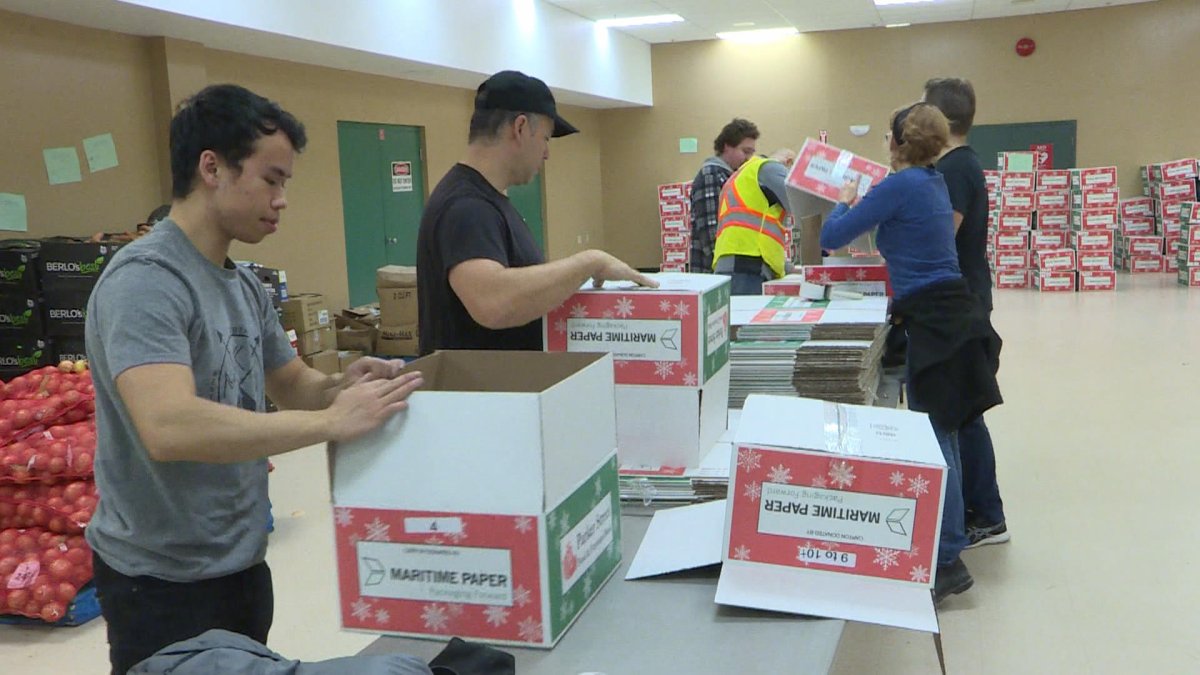 Volunteers prepare boxes soon to be filled with food for a Christmas dinner.