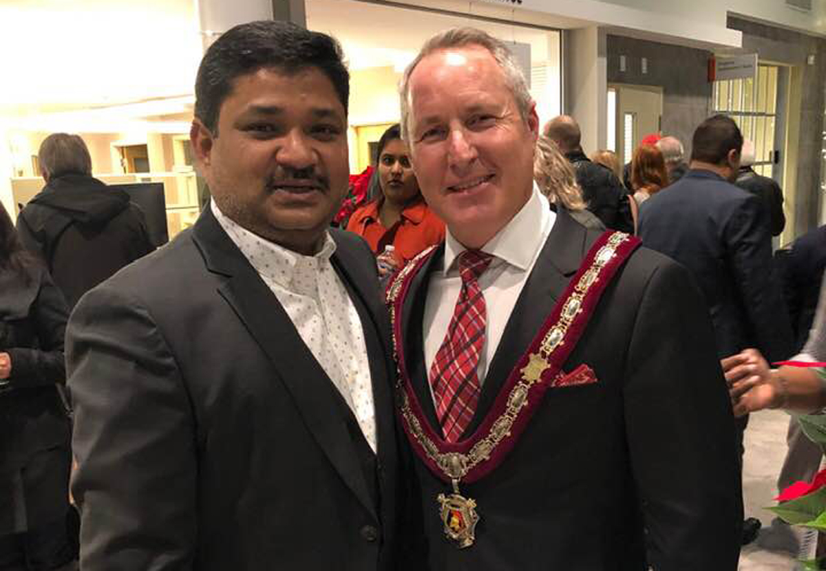 MD Tarekh Rana (left) with Ajax Mayor Shaun Collier.