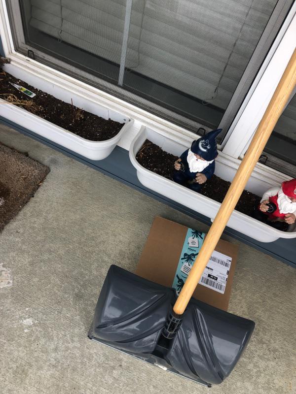 Amazon package hidden behind a shovel.