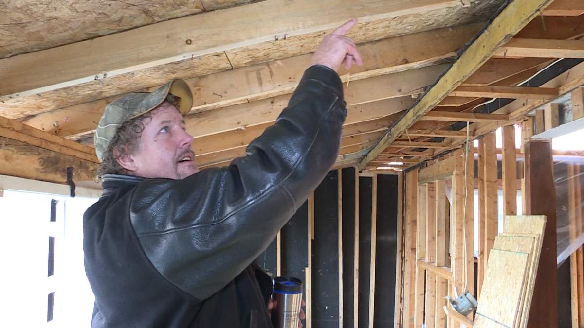 Contractor Rod Reid points to interior ceiling