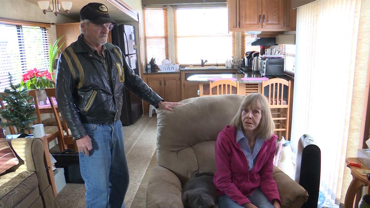 Reg and Terri Dionne inside their travel trailer