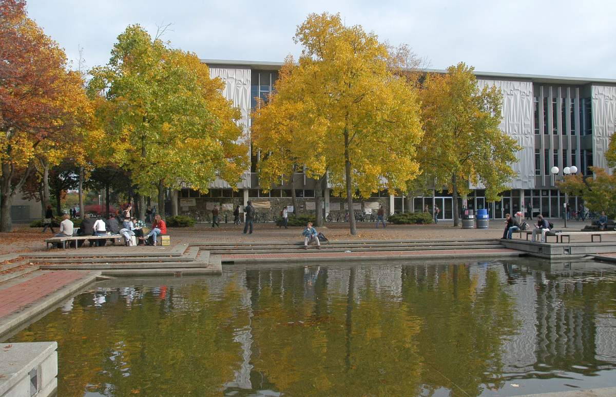 Students around the reflecting pool in front of the McPherson Library building on the University of Victoria campus in Victoria, BC. 