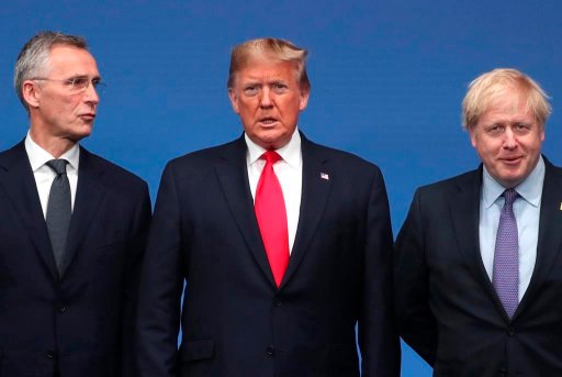 NATO Secretary General Jens Stoltenberg, left, and British Prime Minister Boris Johnson, right, welcome U.S. President Donald Trump during a NATO leaders meeting at The Grove hotel and resort in Watford, Hertfordshire, England, Wednesday, Dec. 4, 2019. NATO Secretary-General Jens Stoltenberg rejected Wednesday French criticism that the military alliance is suffering from brain death, and insisted that the organization is adapting to modern challenges. (AP Photo/Francisco Seco)