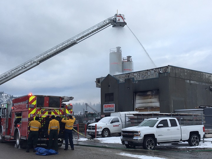 West Kelowna Fire Rescue crews pour water on an industrial blaze along Auburn Road on Friday morning.