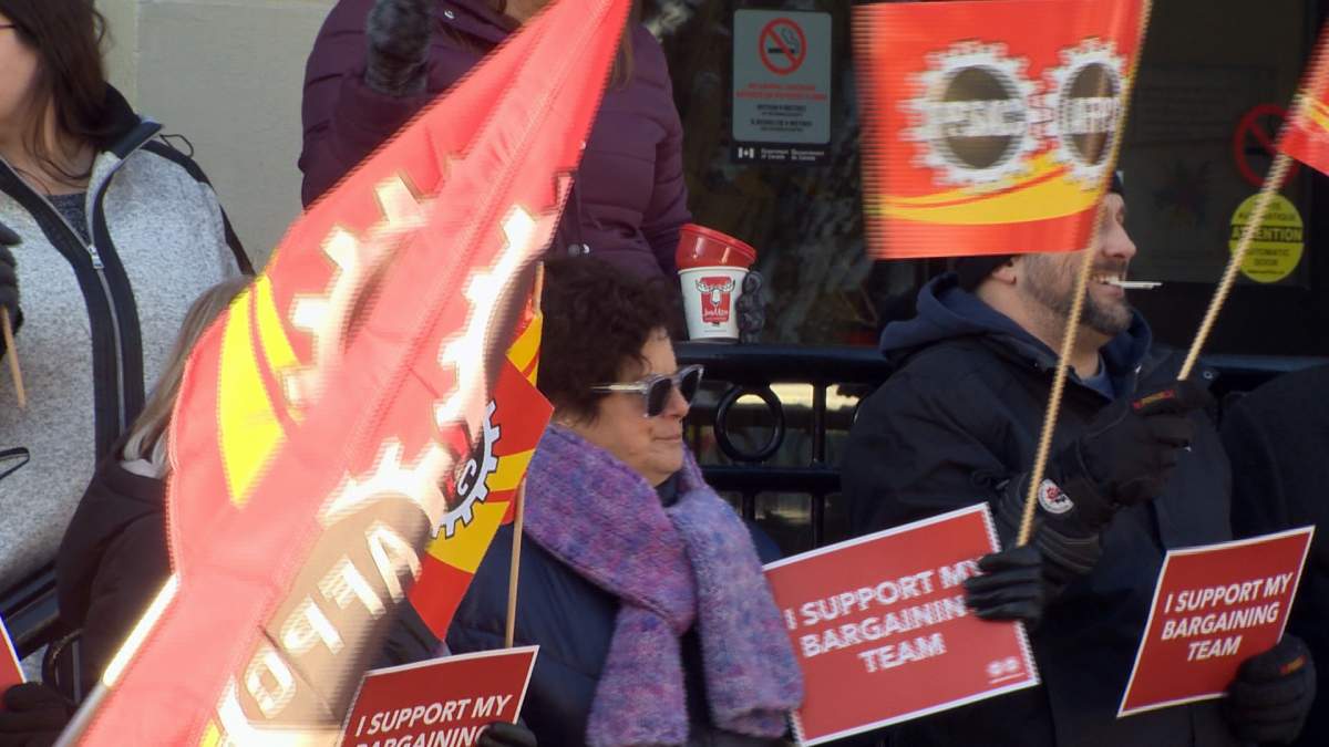 “I support my bargaining team” was among the slogans on signs held by supporters.
