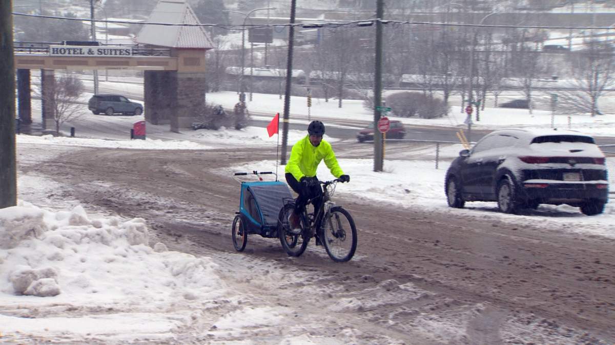 Nick Cameron takes his one-year-old-daughter to daycare by bike, even in the snow.