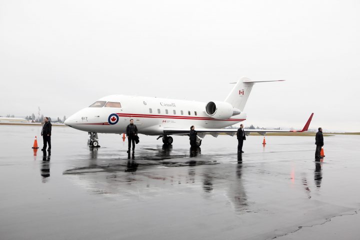 FILE PHOTO: Prime Minister Stephen Harper's security staff look over the Challenger during his arrival at the Shell Aerocentre during his Western tour in North Saanich, B.C., January 7, 2014. 