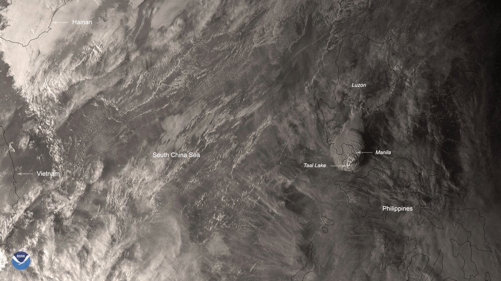 This Jan. 12, 2020, image made available by Himawari-8 satellite via the National Oceanic and Atmospheric Administration (NOAA), shows the eruption of Taal volcano, south of Manila, Philippines. The small volcano near the Philippine capital that draws tourists for its picturesque setting in a lake erupted with a massive plume of ash and steam Sunday, prompting the evacuation of tens of thousands of people and forcing Manila’s international airport to shut down. The annotation of the locations are provided by the source.