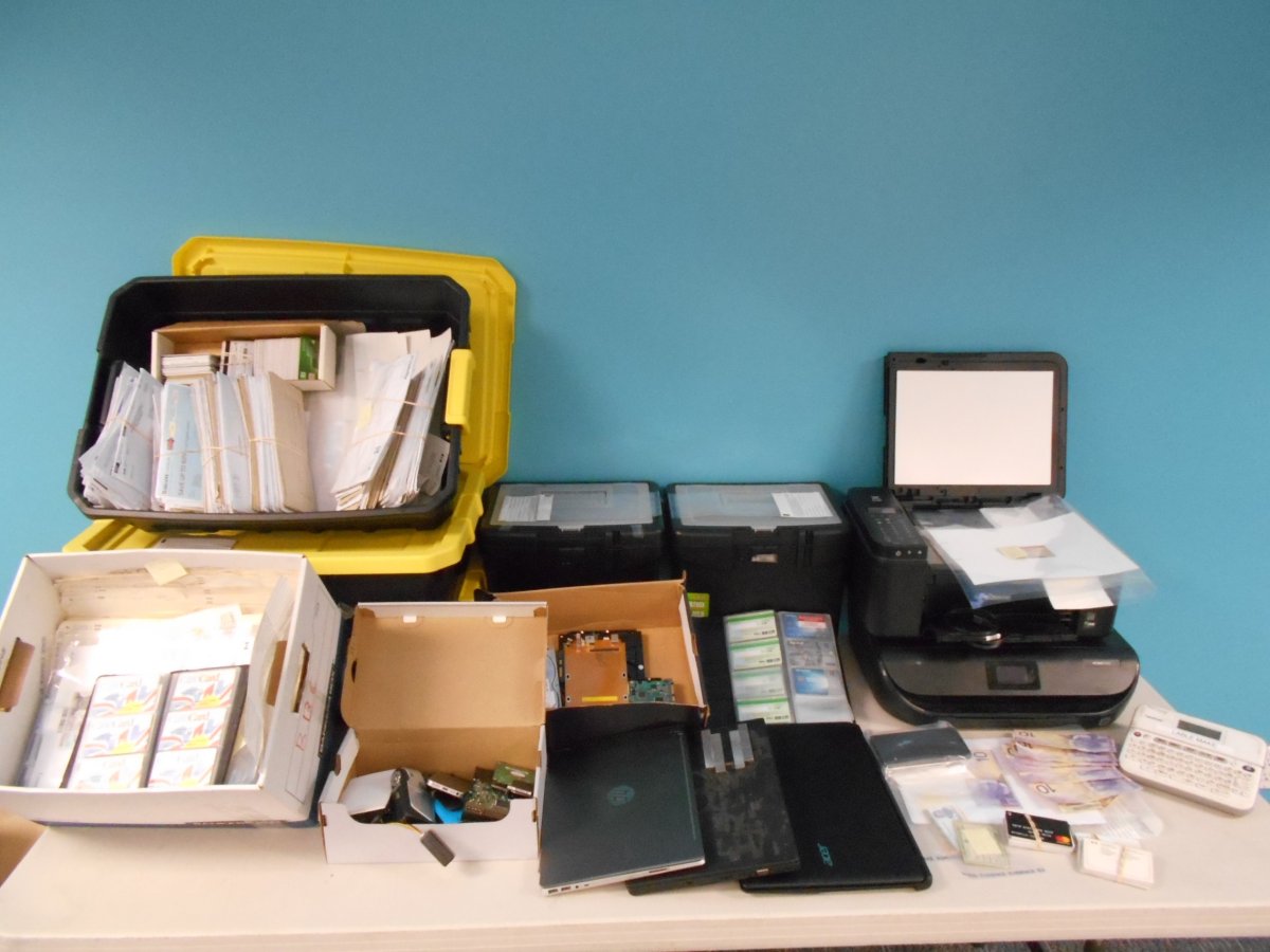 Items seized during an investigation into mail theft and fraud in Surrey. 