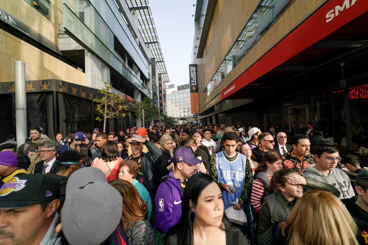 Mourners gather in Microsoft Square near the Staples Center to pay respects to Kobe Bryant after a helicopter crash killed the retired basketball star, in Los Angeles, California, U.S., January 26, 2020.