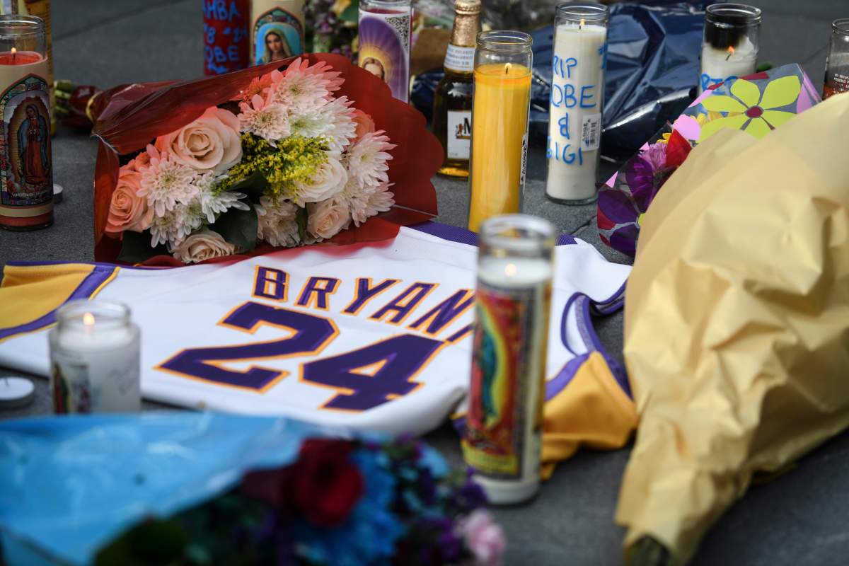 Fans mourn the loss of NBA legend Kobe Bryant outside of the Staples Center in Los Angeles.