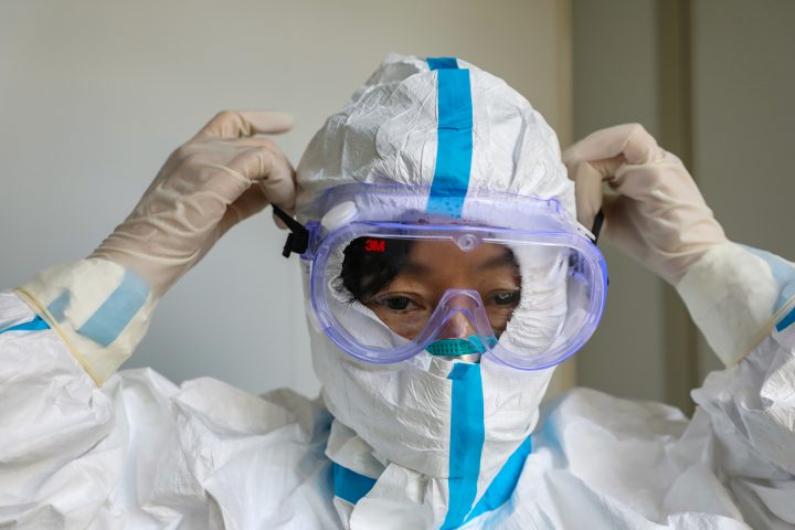 A doctor puts on protective goggles before entering the isolation ward at a hospital, following the outbreak of a new coronavirus in Wuhan, Hubei province, China. Officials in Manitoba said Friday the risk remains low here.
