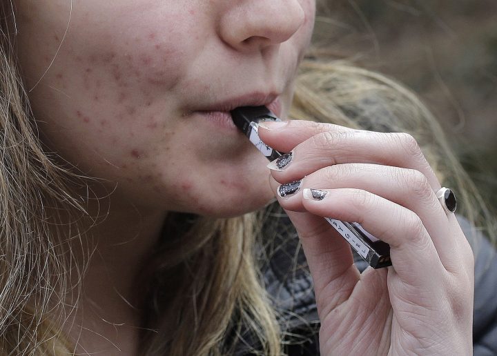 A high school student uses a vaping device near a school campus in Cambridge, Mass. While there is consensus within organizations with that youth vaping needs to be curbed, some are questioning if new measures in Saskatchewan go too far — or not far enough.