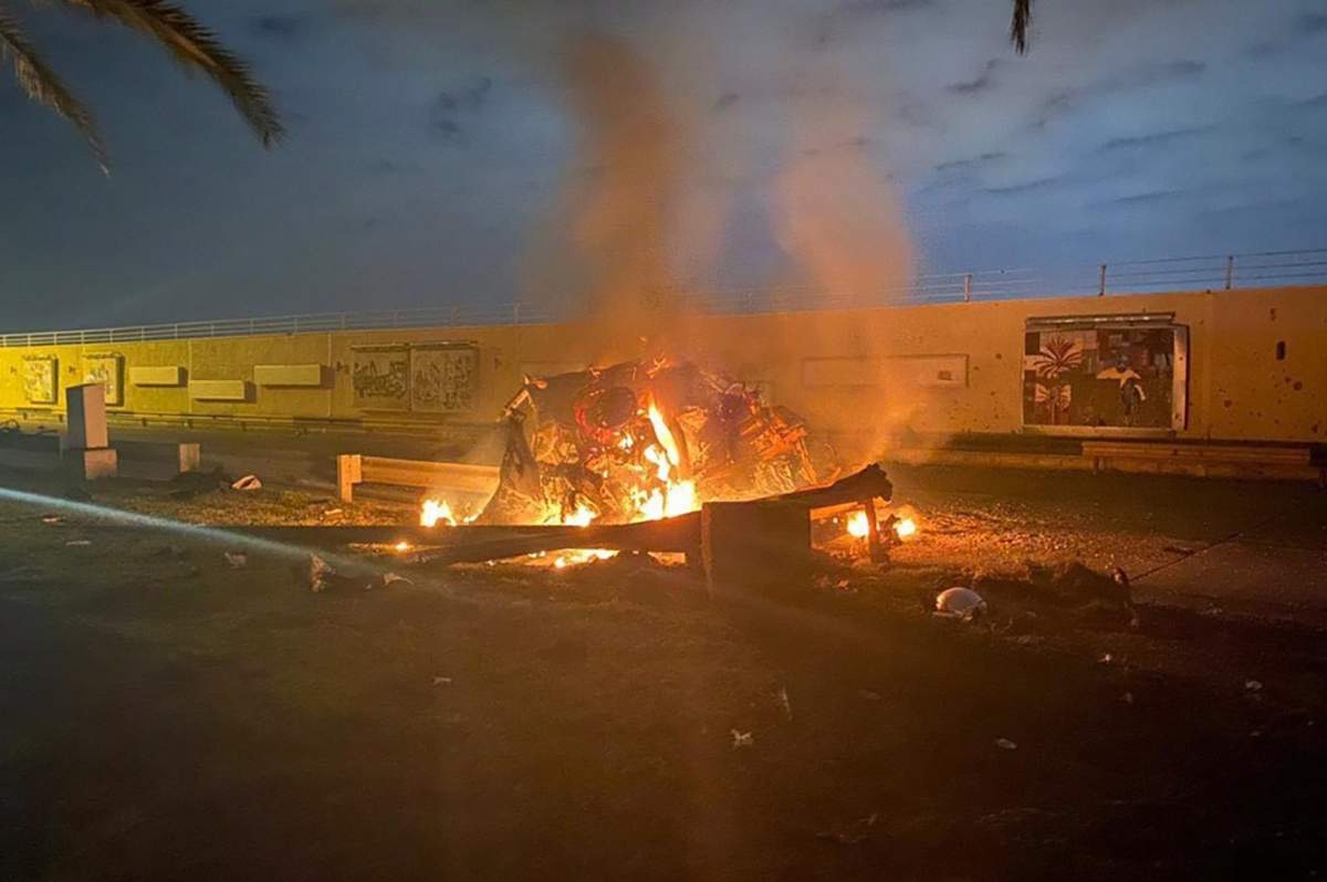 This photo released by the Iraqi Prime Minister Press Office shows a burning vehicle at the Baghdad International Airport following an airstrike in Baghdad, Iraq, early Friday, Jan. 3, 2020.