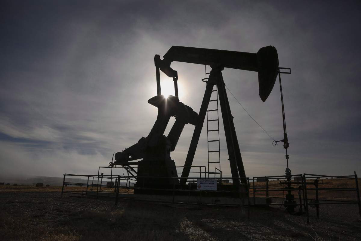 A pumpjack works at a well head on an oil and gas installation near Cremona, Alta., Saturday, Oct. 29, 2016.