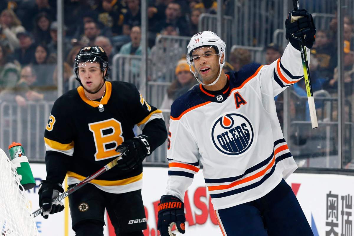 Edmonton Oilers' Darnell Nurse (25) celebrates his goal in front of Boston Bruins' Charlie McAvoy (73) during the second period on an NHL hockey game in Boston, Saturday, Jan. 4, 2020. (AP Photo/Michael Dwyer).