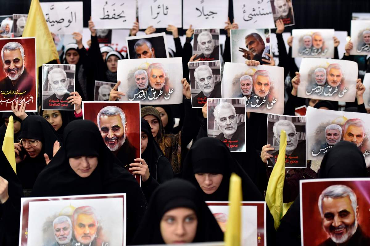 Women supporters of Hezbollah carry pictures of slain the Abu Mahdi al-Muhandis (L) with Arabic words reads ‘On the road to Quds’ as they wait for a televised speech of Hezbollah Secretary-General Sayed Hassan Nasrallah in the southern suburb of Beirut, Lebanon, Jan. 5, 2020.
