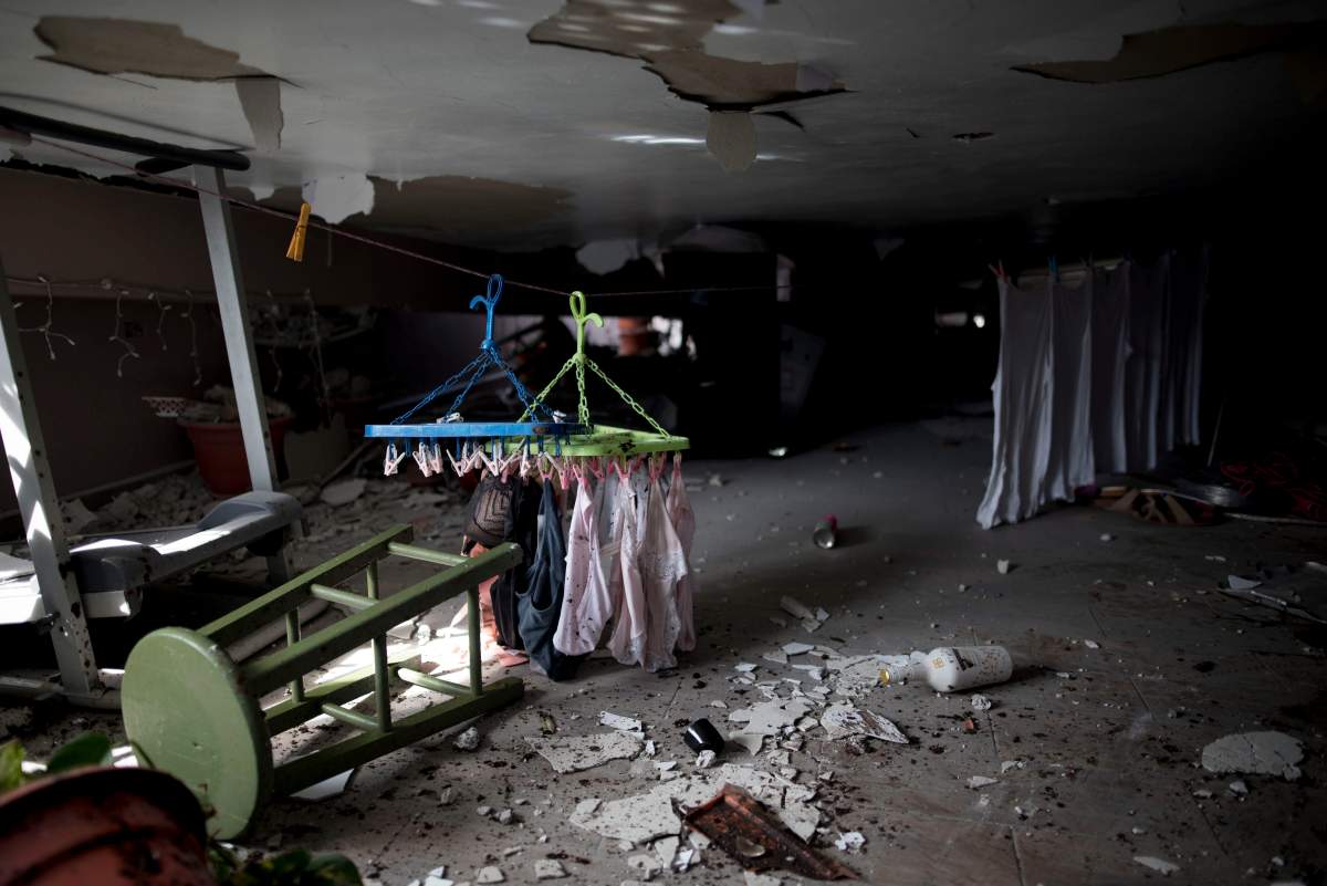 Clothing hangs to dry inside on the top floor, the second floor, of a home with a partially collapsed roof after an earthquake hit Guanica, Puerto Rico, Monday, Jan. 6, 2020.  (AP Photo/Carlos Giusti)