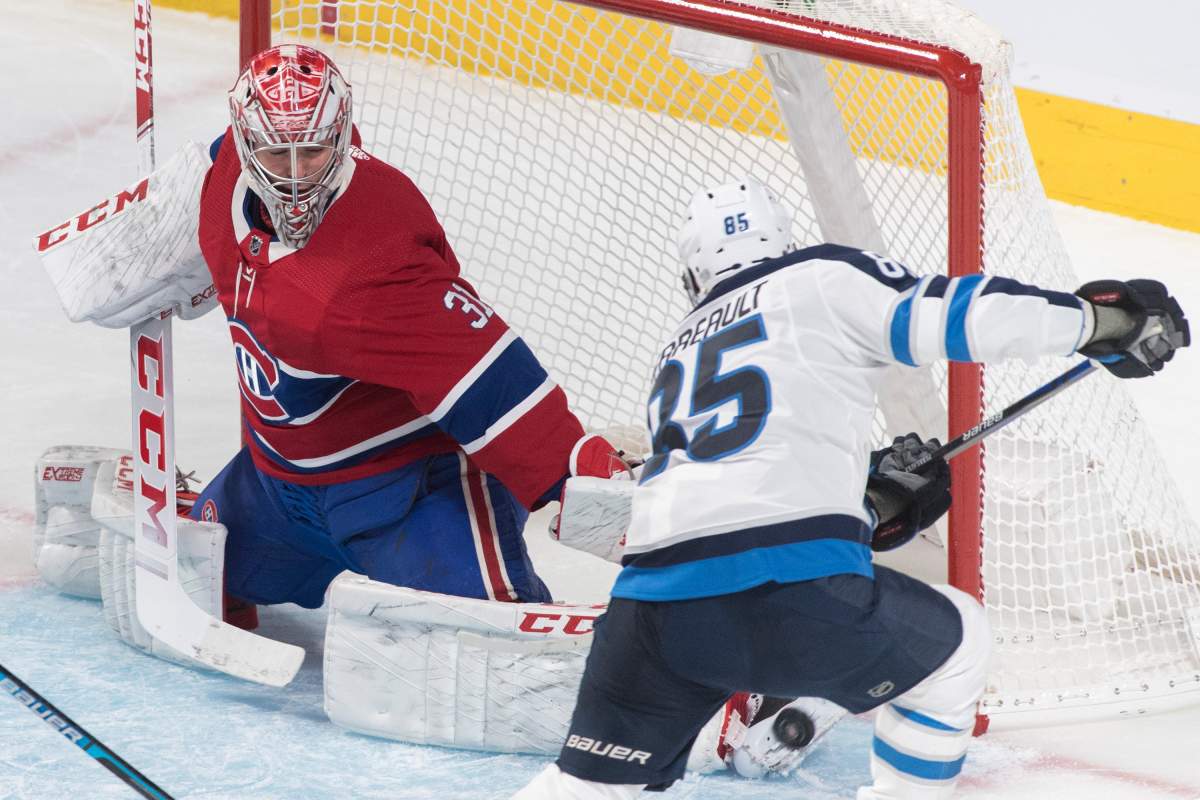 Montreal Canadiens goaltender Carey Price makes a save against the Winnipeg Jets’ Mathieu Perreault during first-period NHL hockey action in Montreal, Monday, Jan. 6, 2020.