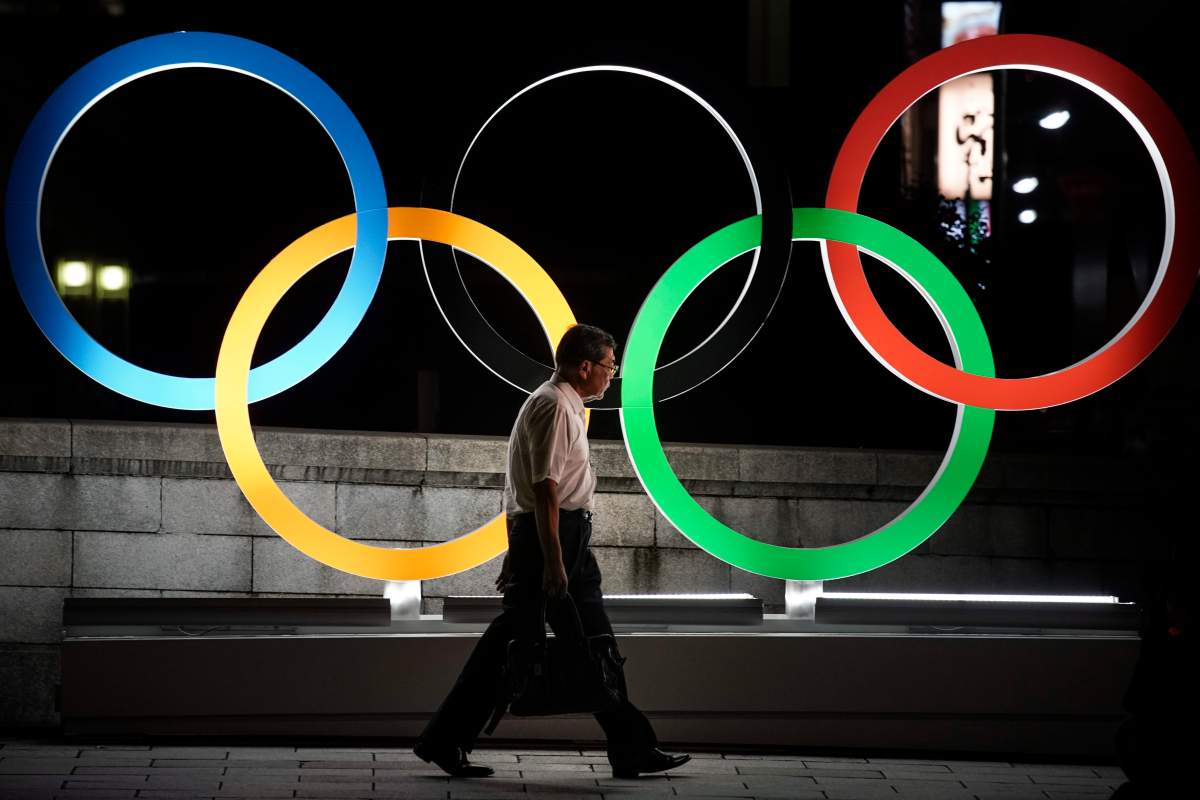 A man walks past the Olympic rings Tuesday, July 23, 2019, in Tokyo, as Japan marks a year-to-go until hosting the summer games with Olympic medals being unveiled Wednesday as part of daylong ceremonies around the Japanese capital. The Canadian Olympic Committee released its marketing guidelines Tuesday for athletes and their personal sponsors during the 2020 Olympics in Tokyo from July 24 through Aug. 9. 