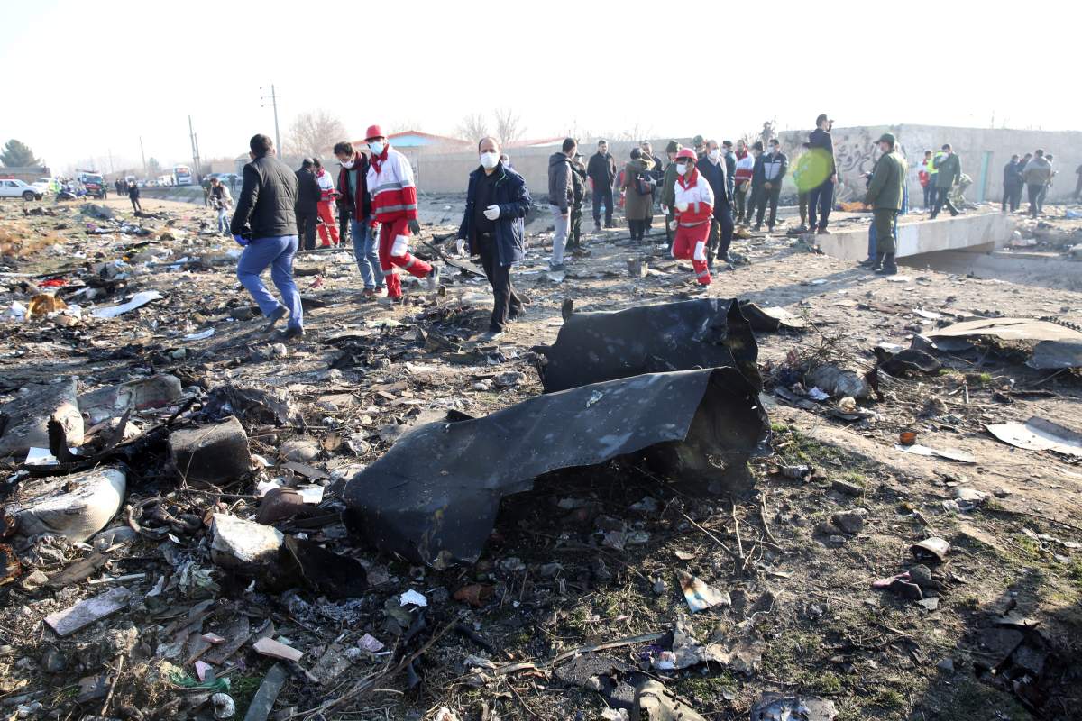Emergency services personnel walk amidst the wreckage after an Ukraine International Airlines Boeing 737-800 carrying 176 people crashed near Imam Khomeini Airport in Tehran, killing everyone on board; in Shahriar, Iran, 08 January 2020.