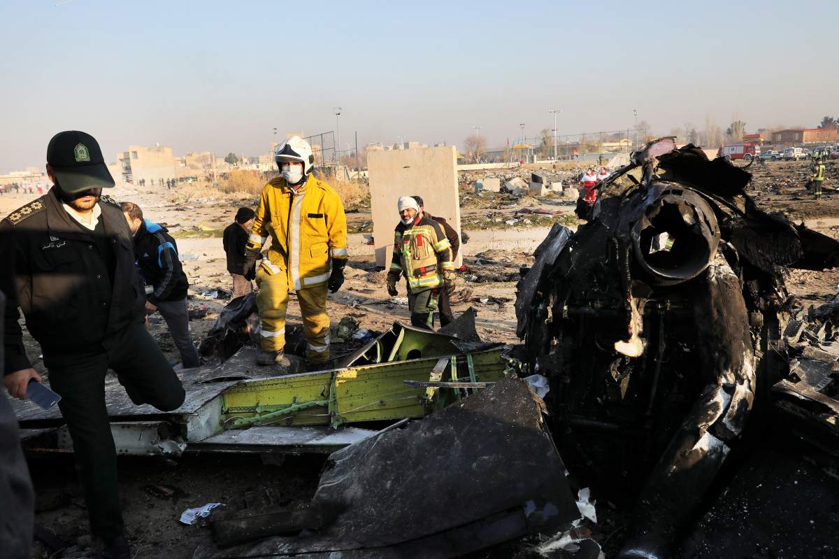 Debris is seen from an Ukrainian plane which crashed as authorities work at the scene in Shahedshahr, southwest of the capital Tehran, Iran, Wednesday, Jan. 8, 2020. A Ukrainian airplane carrying 176 people crashed on Wednesday shortly after takeoff from Tehran’s main airport, killing all onboard.