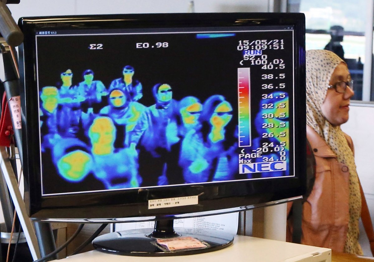 FILE - In this May 21, 2015, file photo, a thermal camera monitor shows the body temperature of passengers arriving from overseas against possible MERS, Middle East Respiratory Syndrome, virus at the Incheon International Airport in Incheon, South Korea.