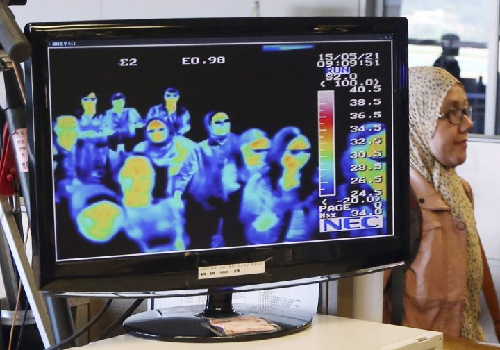 FILE - In this May 21, 2015, file photo, a thermal camera monitor shows the body temperature of passengers arriving from overseas against possible MERS, Middle East Respiratory Syndrome, virus at the Incheon International Airport in Incheon, South Korea. 