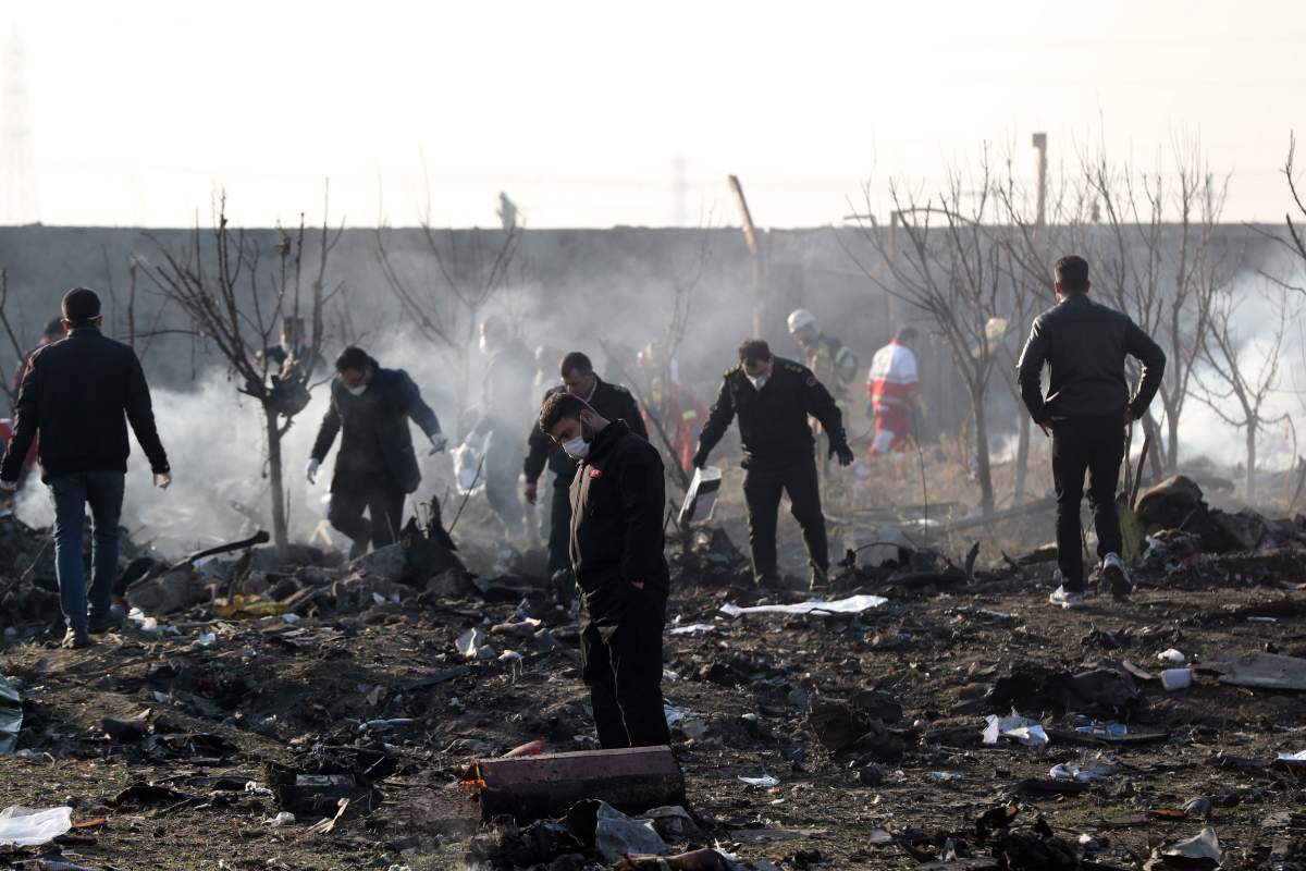 Officials inspect the wreckage after an Ukraine International Airlines Boeing 737-800 carrying 176 people crashed near Imam Khomeini Airport in Tehran, killing everyone on board, in Shahriar, Iran, 08 January 2020.