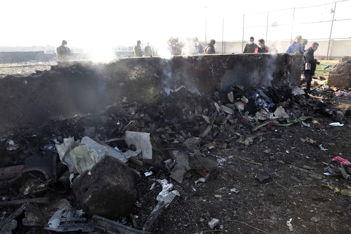 epa08112157 A view of the wreckage after an Ukraine International Airlines Boeing 737-800 carrying 176 people crashed near Imam Khomeini Airport in Tehran, killing everyone on board, in Shahriar, Iran, 08 January 2020. EPA/ABEDIN TAHERKENAREH