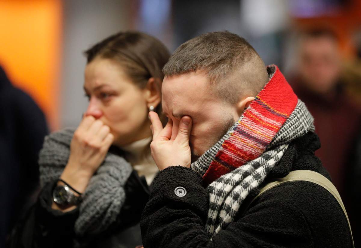 Relatives, colleagues, and friends of crew members of the Ukraine International Airlines Flight PS752 which crashed near Tehran lay flowers and light candles at Boryspil International Airport in Kiev, Ukraine, Jan. 8, 2020.